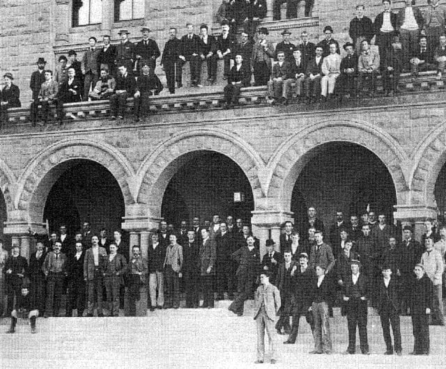 a group of people standing on a bridge