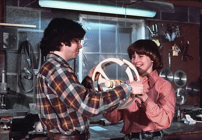 a man and a woman holding a wheel