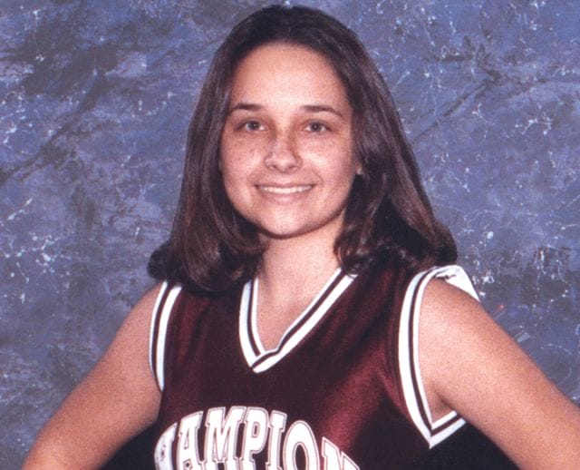a woman in a basketball jersey