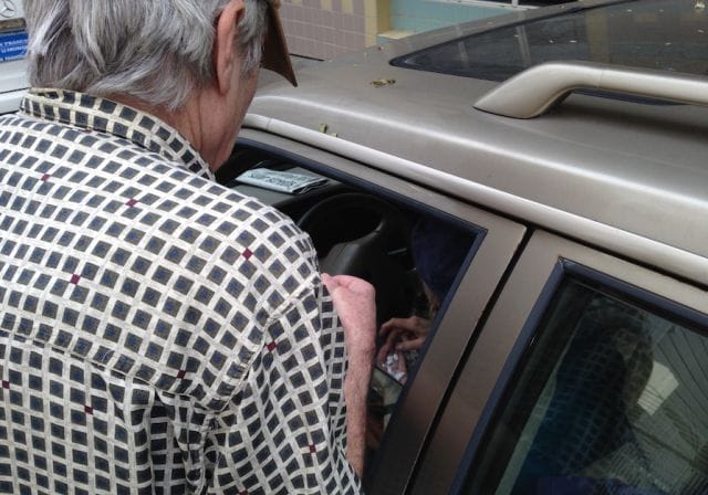 a person looking at a baby in a car