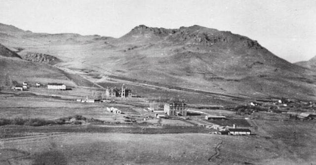 a black and white photo of a town in the valley