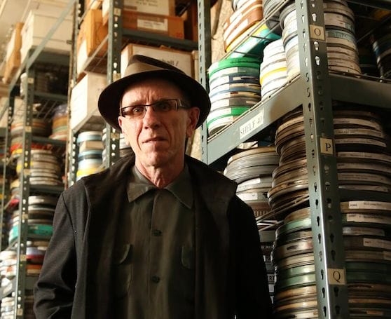 Joseph Paul Franklin standing in front of a stack of metal boxes