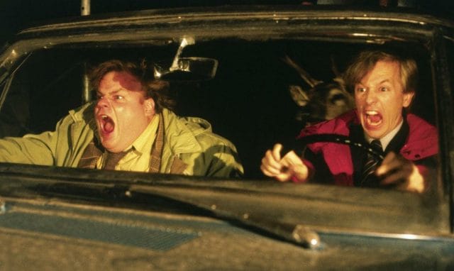 a man and a woman in a car with their mouths open