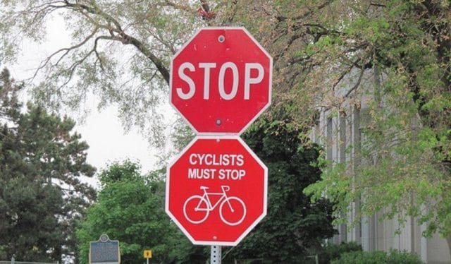 a stop sign with a bicycle on it
