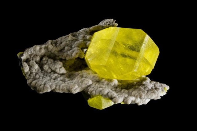 a rock with a yellow and green substance on it