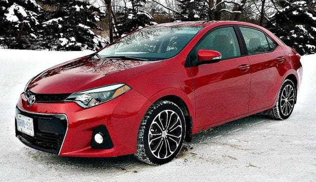 a red car parked in the snow