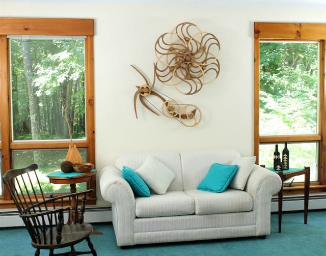 a living room with a white couch and a table with a blue pillow