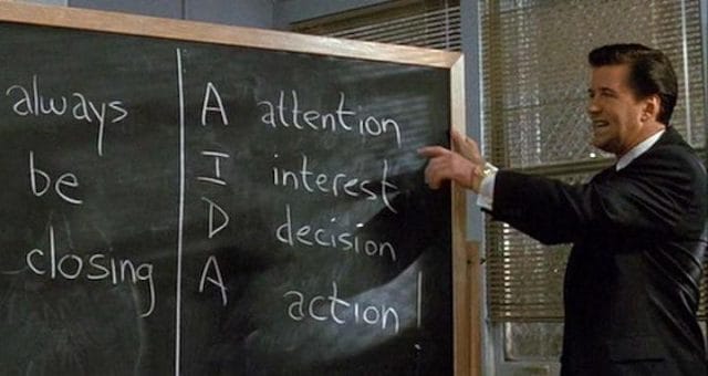 a man writing on a chalkboard