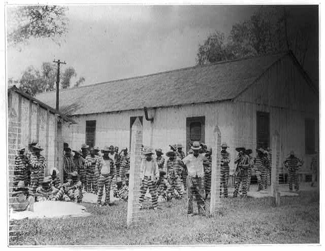 a group of people standing outside a house