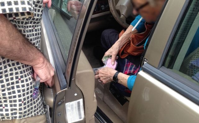 a man holding a bottle in a car