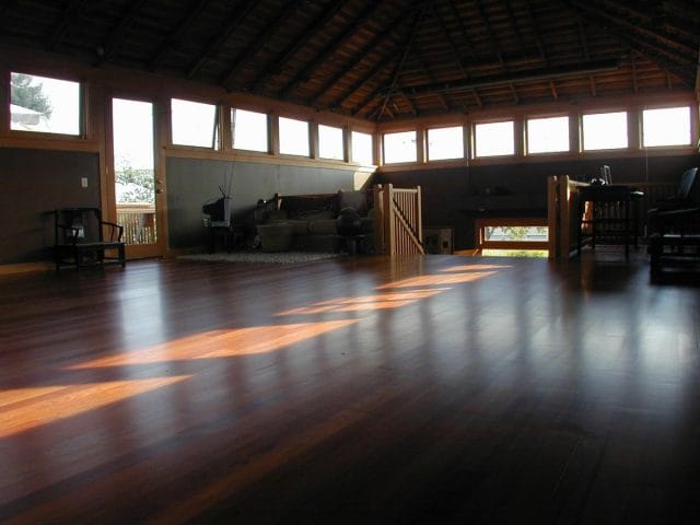 a large empty room with a wood floor and a wood floor