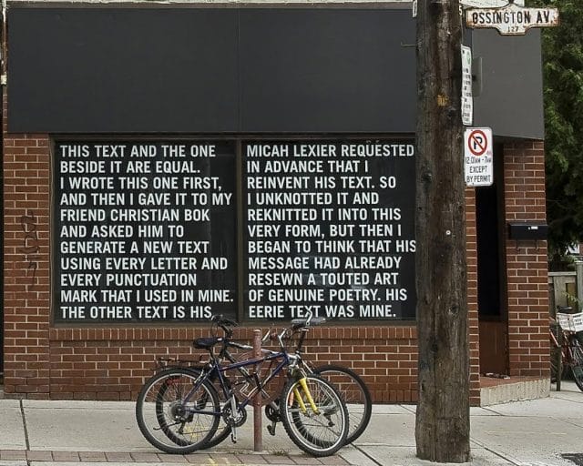 a bicycle is parked next to a sign