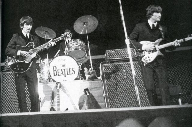 a group of men playing instruments on a stage