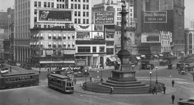 a city street with a bus and people