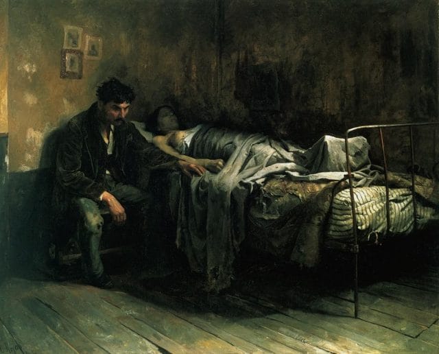 a man sitting on a bed with a man lying on the bed