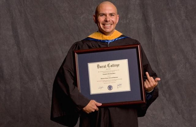 Pitbull holding a certificate