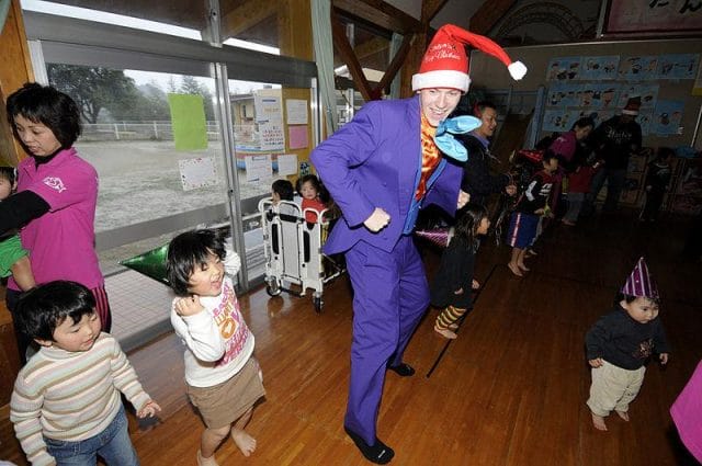 a person in a garment dancing with children