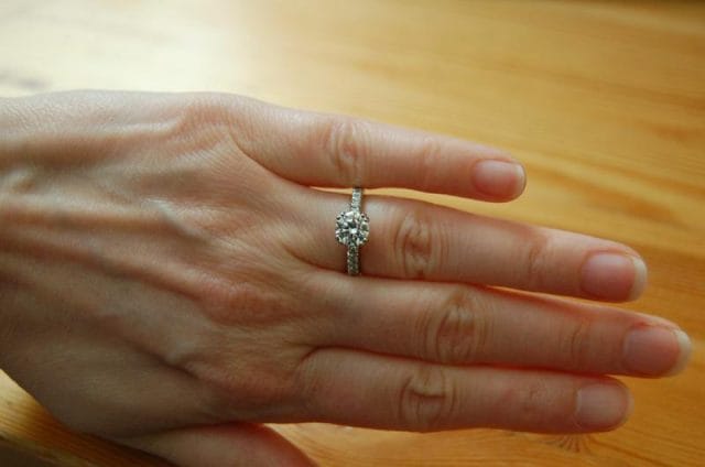 a person's hand with a ring on it