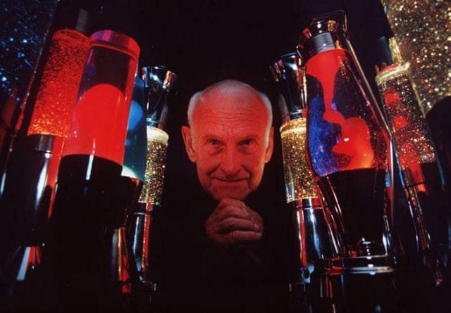 Edward Craven Walker holding a bunch of red and blue swords