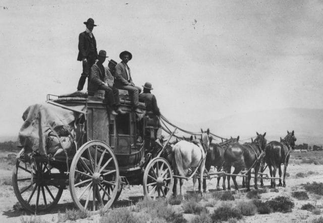 a group of people riding on a horse drawn carriage