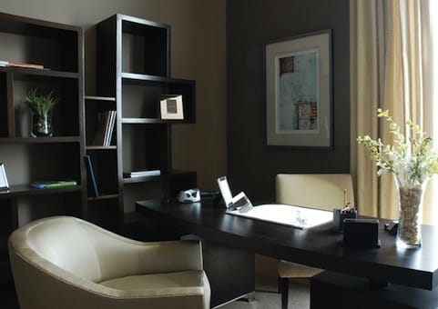 a desk with a chair and a bookcase