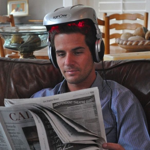 a man wearing headphones and reading a book