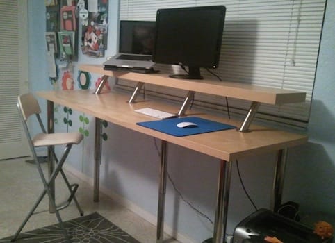 a desk with a computer and a chair