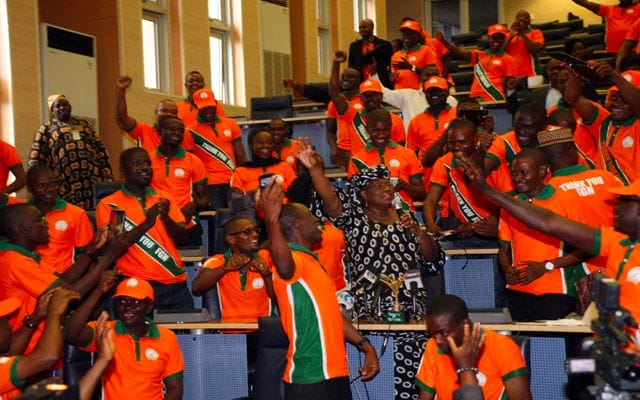 a group of people in orange shirts