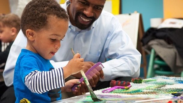 a man and a boy painting