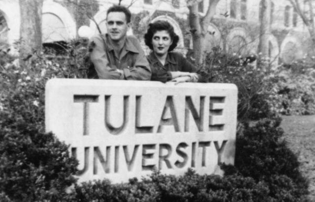 a man and woman holding a sign