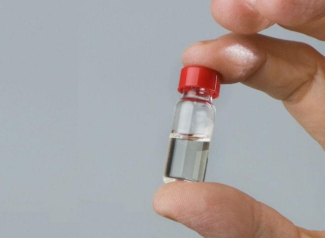 a person holding a small plastic bottle