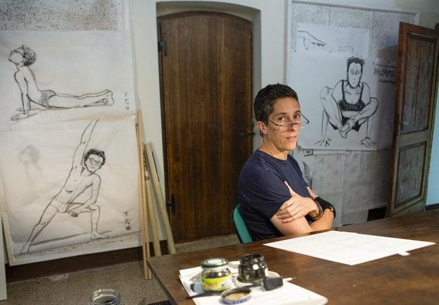 Alison Bechdel sitting at a table