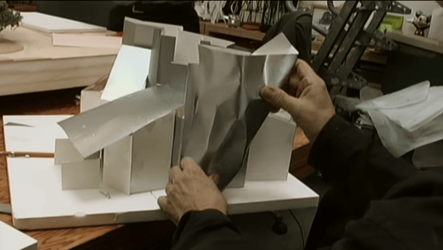 a person holding a white laptop