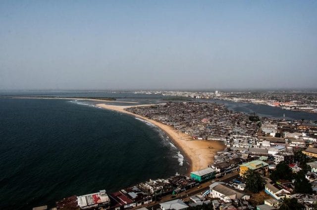 a beach with buildings and water