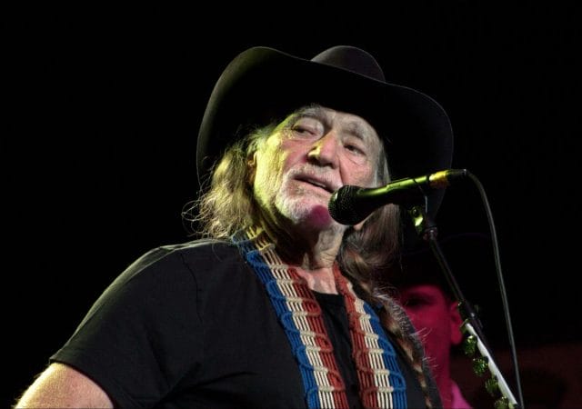 Willie Nelson with a hat and microphone