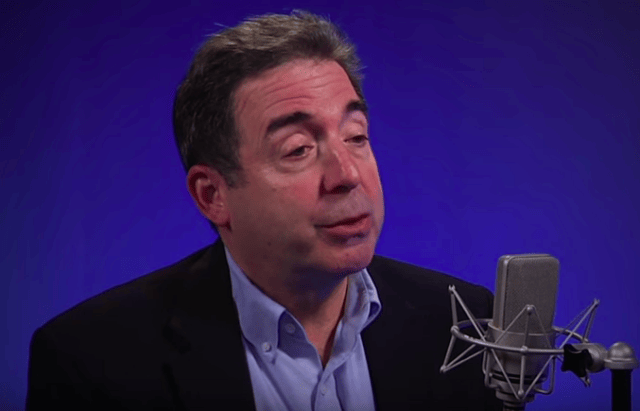 Russ Roberts speaking into a microphone