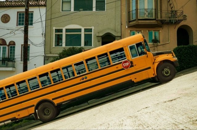 a yellow bus parked on the side of a street
