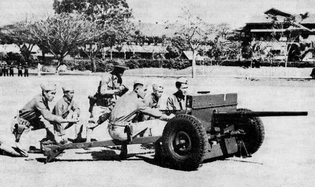 a group of men sitting on a vehicle