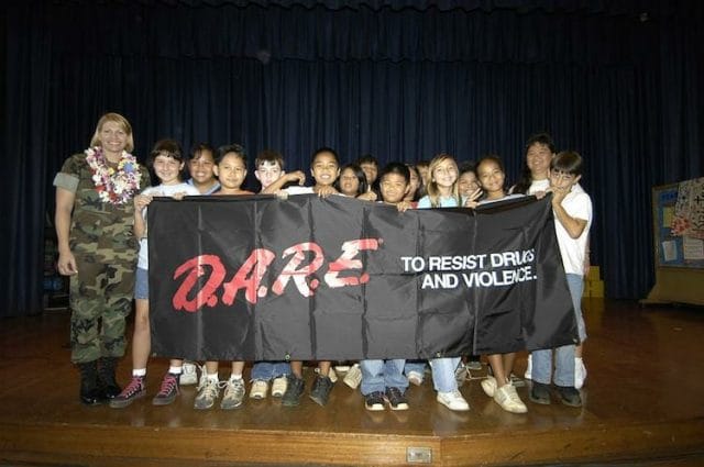 a group of people holding a sign