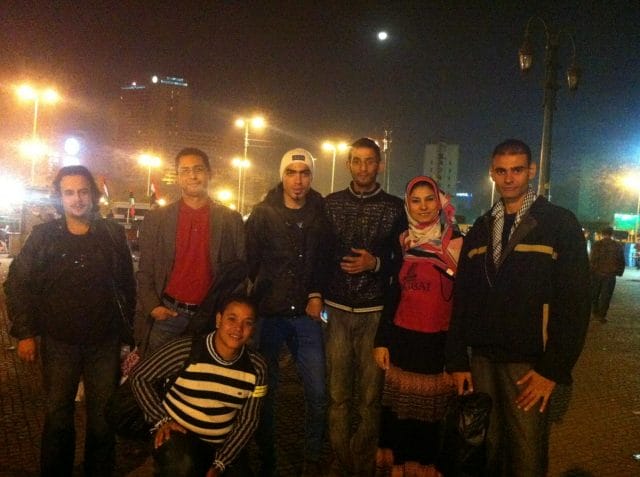 a group of people posing for a photo at night