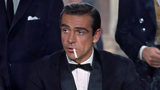 Sean Connery in a suit smoking a cigarette