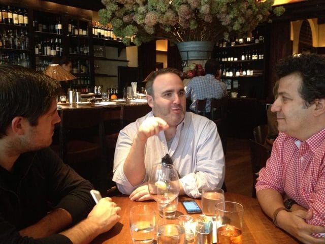 a group of men sitting at a table with drinks