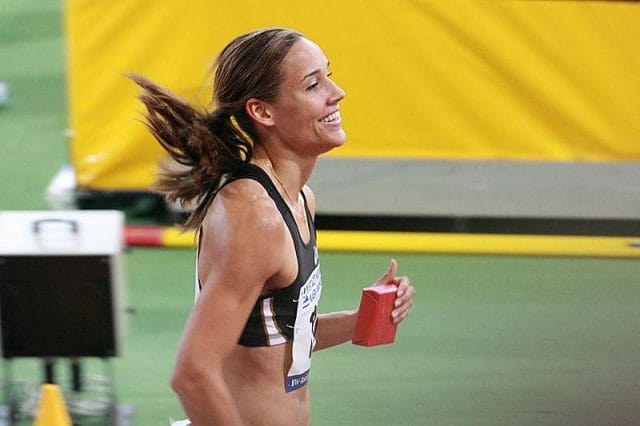a woman in a track uniform