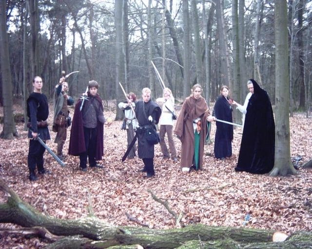 a group of people in robes in a forest