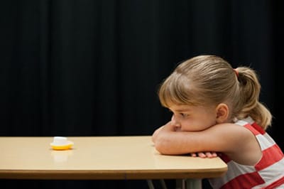 a little girl sitting at a table