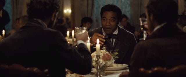 Chiwetel Ejiofor holding a glass of wine