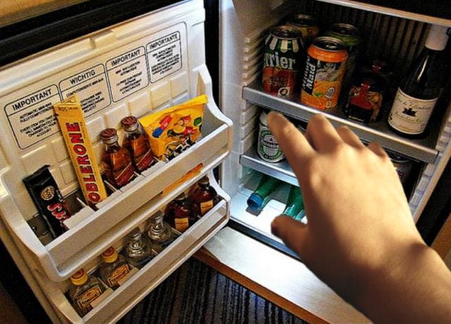 a hand reaching into a refrigerator