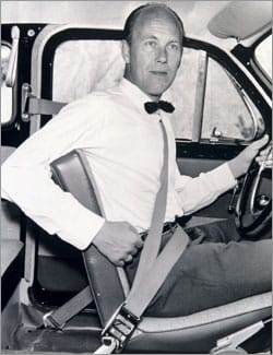 Nils Bohlin in a tuxedo sitting in a car
