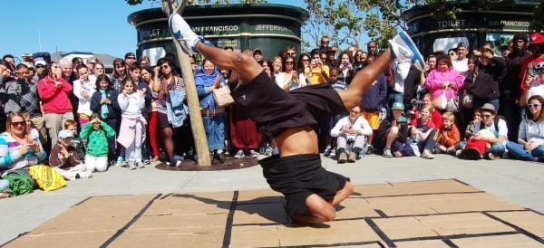 a person doing a handstand in front of a crowd