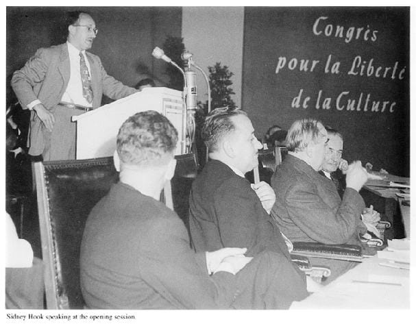 a group of men sitting at a table